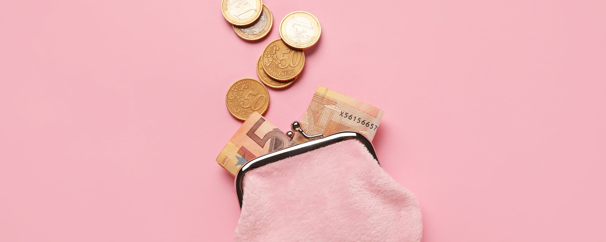 Kleine portemonnee op een roze achtergrond waar munt- en briefgeld uit steekt.